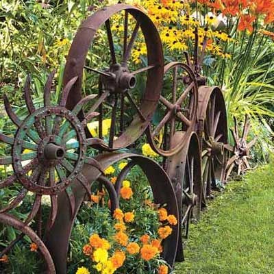 A fence made up of old metal wheels